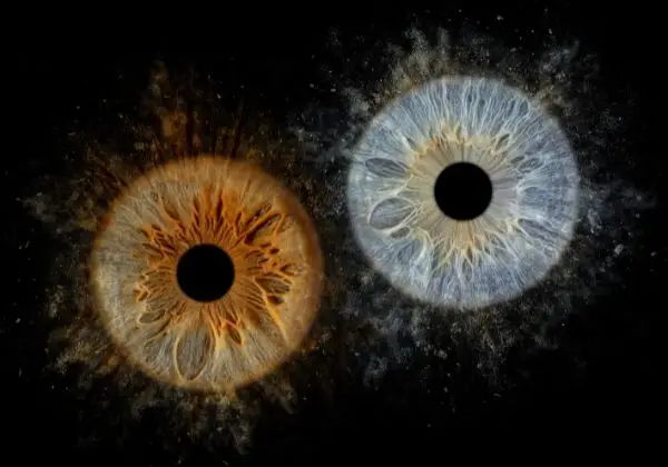 a pair of eyeballs with black circles and effect sand